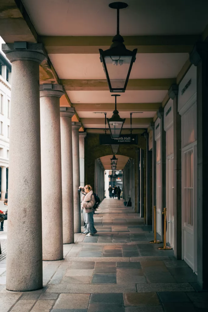 fujifilm-xt30-24-shots-street-photography-london-12 Young woman taking a photo in Covent garden. Street photography like an old film camera with a Fujifilm X-T30